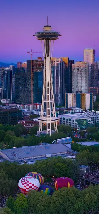The Space Needle and Seattle skyline at twilight above The Seattle Glow